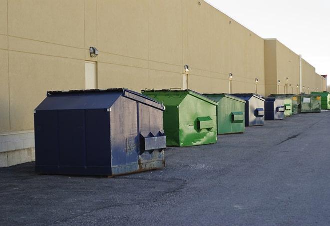 a red construction dumpster placed in front of a building under construction in Goshen CA